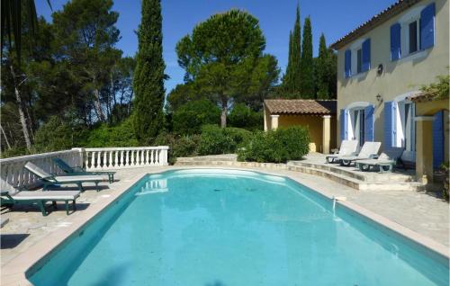 a swimming pool with chairs and a house at 6 Bedroom Awesome Home In Entrecasteaux in Entrecasteaux