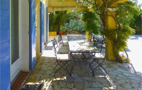 a patio with a table and chairs on a patio at 6 Bedroom Awesome Home In Entrecasteaux in Entrecasteaux