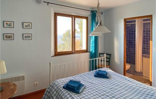 a bedroom with a bed with blue towels on it at 6 Bedroom Awesome Home In Entrecasteaux in Entrecasteaux