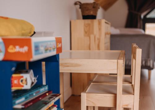 a table and a chair in a room with boxes at Lasosfera Lasówka in Lasowka