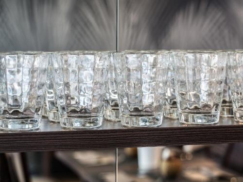 a row of empty glasses sitting on a table at Boutique Hotel Bellevue Rheinfelden / Basel in Rheinfelden