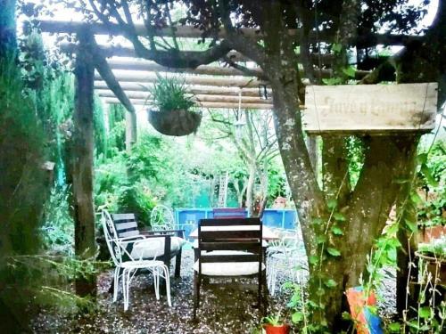 a patio with a table and chairs under a pergola at Naturaleza, Confort y Magnificas vistas a Sierra de Gata TR-CC-00490 in Gata