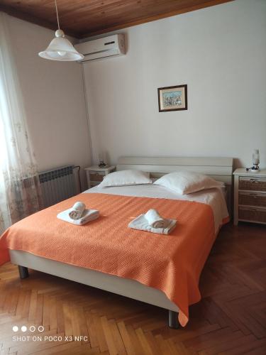 a bedroom with a bed with two towels on it at Villa Radić in Makarska