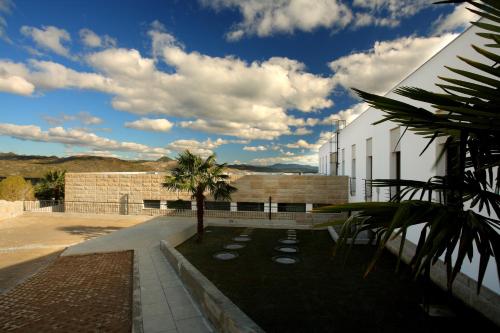a building with a palm tree in front of it at HI Alijo - Pousada de Juventude in Alijó