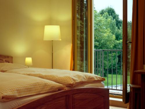 a bedroom with two beds and a large window at Bio Hotel Kipperquelle in Weimar