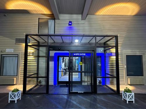 an entrance to a building with a blue door at Motel 6-Greensboro, NC - Airport in Greensboro