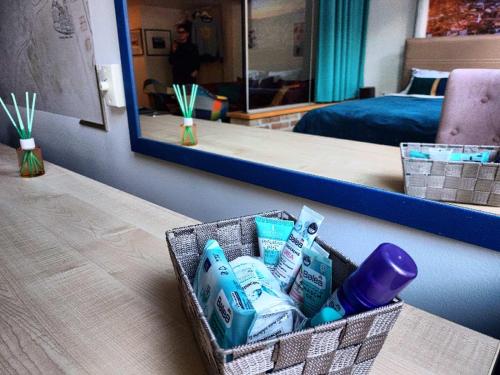 a basket of toothbrushes and toothpaste on a table in a room at KIZZ Apartment in Sarajevo