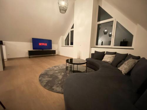 a living room with a couch and a tv at OASIS: Close to Munich - 4 Bedrooms - Kitchen in Dachau