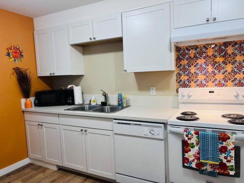a kitchen with white cabinets and a sink at Talavera in Salem