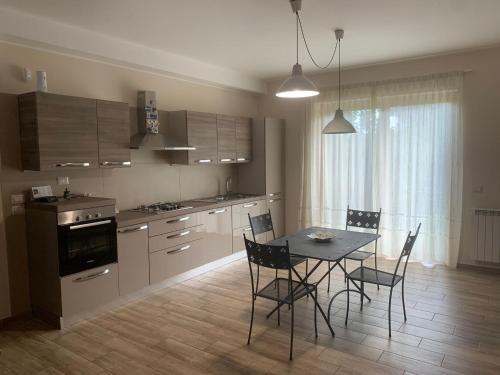 a kitchen with a table and chairs in a room at Etna holiday in Zafferana Etnea