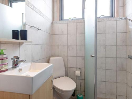 a bathroom with a toilet and a sink and a shower at Holiday home Thisted XLIX in Thisted