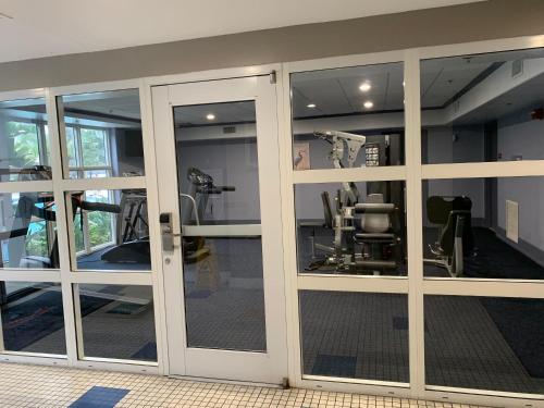 a gym with sliding glass doors in a room at Disney 1 mile , Blue Heron 1 room 2 bath,amenities,6 guests, walk to restaurants, no fees at check in in Orlando