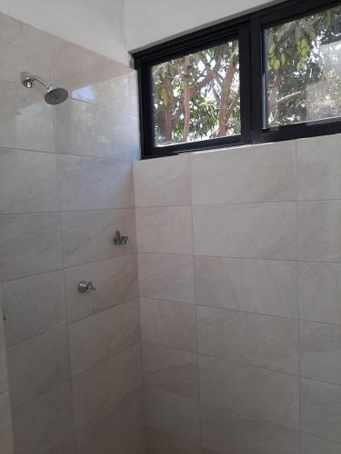 a bathroom with a shower and a window at Casa Vista Hermosa in Vista Hermosa