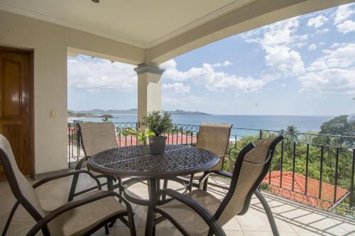 a table and chairs on a balcony with a view of the ocean at Oceanica 824 in Playa Flamingo