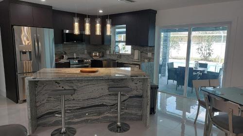 a kitchen with a wooden island in the middle of a room at CAPE CORAL CANALFRONT in Cape Coral