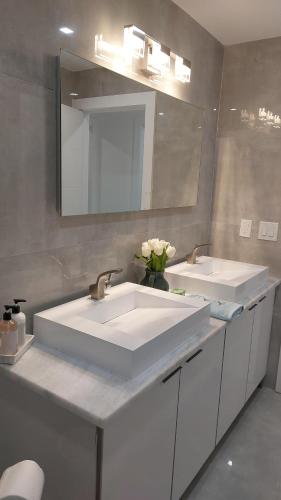 a bathroom with two sinks and a mirror at CAPE CORAL CANALFRONT in Cape Coral