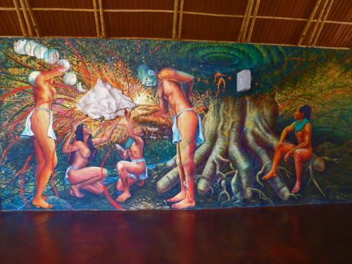 a mural on the wall of a room with people on it at AXKAN PALENQUE, ALBERCAS, GASTRONOMIA MAR y TIERRA & TRAVEL AGENCY in Palenque