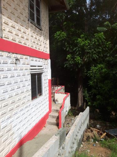 a side of a building with a fence next to it at Cocoa Cabana in Scarborough