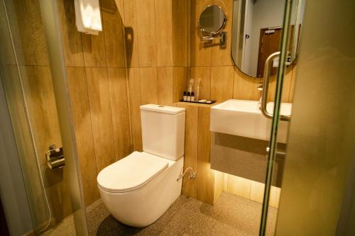 a bathroom with a toilet and a sink at Hotel Bencoolen at Hong Kong Street in Singapore