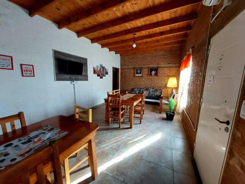 a living room with a table and a dining room at Cabaña Sarita in Santa Rosa