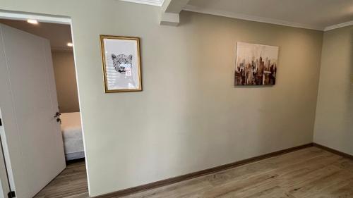 a room with two pictures on a wall at Rengo Central Market in Rengo