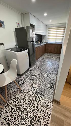 a kitchen with a black and white tile floor at Rengo Central Market in Rengo