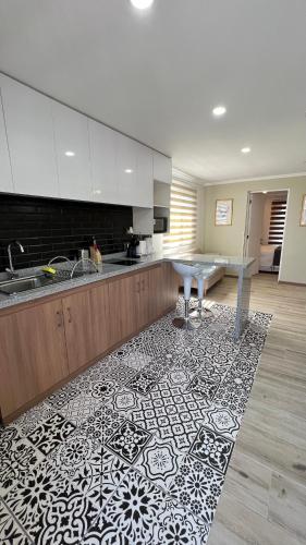 a kitchen with a sink and a table on a rug at Rengo Central Market in Rengo