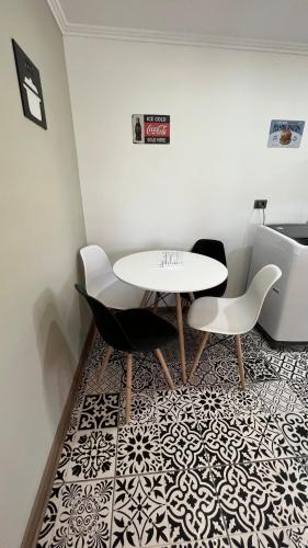 a dining room with a table and two chairs at Rengo Central Market in Rengo