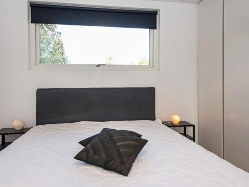 a bedroom with a white bed with a window at 8 person holiday home in Knebel-By Traum in Knebel