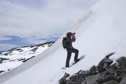 a man taking a picture on a snowboard on a mountain at Chile Wild - Las Vertientes in Malalcahuello