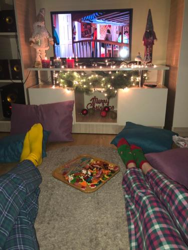 a living room with two couches and a christmasmasreens at TREFOIL in Lori Berd