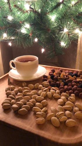 a cup of coffee sitting on a table with peanuts at TREFOIL in Lori Berd