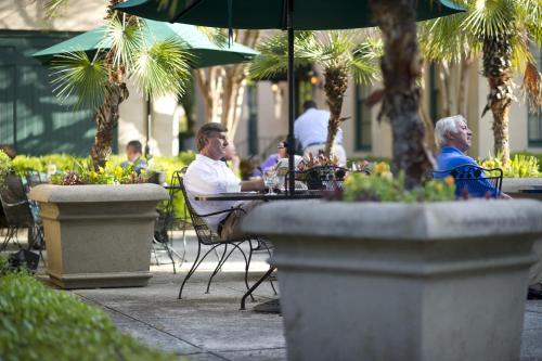 a group of people sitting at an outdoor table at John Rutledge House Inn in Charleston
