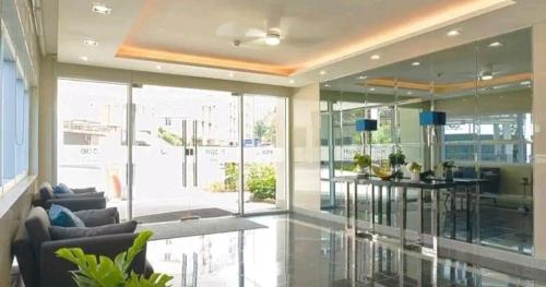 a lobby with glass walls and a bar in a building at Staycation ni Inday in Trece Martires