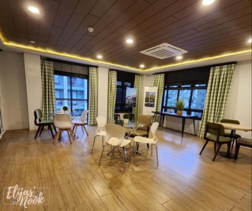 a meeting room with chairs and tables and windows at Casa Lucas in Tagaytay