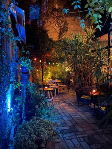 a patio with tables and chairs at night at Bed and Breakfast "Caffe-caffe" in Kikinda