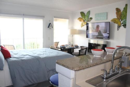1 dormitorio con 1 cama y lavamanos y cocina en Fun-N-Sun with Spectacular Ocean Views en Tampa