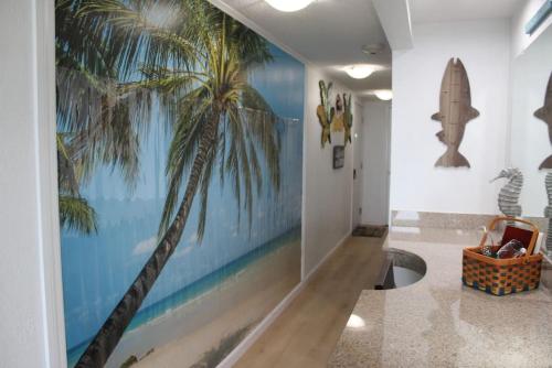 a hallway with a mural of a palm tree on the wall at Fun-N-Sun with Spectacular Ocean Views in Tampa