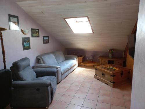 a living room with a couch and a table at Gite Le Chamoyard in Chamoux-sur-Gelon