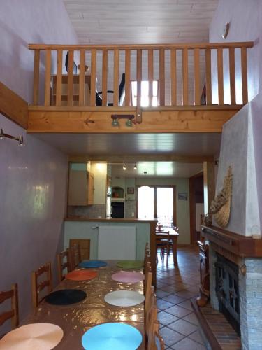 a dining room with a table and a staircase at Gite Le Chamoyard in Chamoux-sur-Gelon