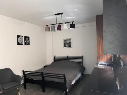 a bedroom with a bed and a chair and lights at Maria's Apartment 2 in Galata
