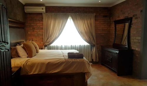 Ένα ή περισσότερα κρεβάτια σε δωμάτιο στο Maretlwane Guesthouse