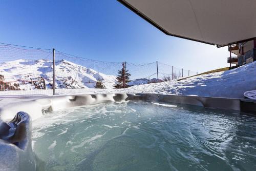 a hot tub with snow covered mountains in the background at Luxury Avoriaz Chalet with hot tub in Avoriaz
