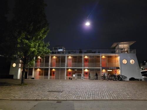 a building at night with a moon in the sky at Hotel CPH Living in Copenhagen