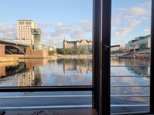 a window with a view of a river and buildings at Hotel CPH Living in Copenhagen
