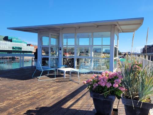 a patio with a table and chairs and flowers at Hotel CPH Living in Copenhagen