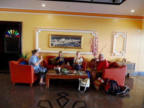 a group of people sitting on a couch in a living room at Falaj Daris Hotel in Nizwa