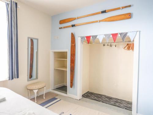 a room with a closet with surfboards on the wall at Gadlys House 62 in Beaumaris