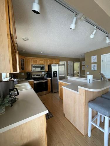 a large kitchen with a large island in the middle at 120 Creel Home away from Home for 22 at the Lake in Linn Creek