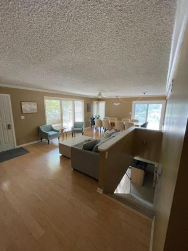a large living room with a couch and a table at 120 Creel Home away from Home for 22 at the Lake in Linn Creek